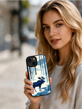 Lifestyle view of a person holding The Quiet Moose iPhone 13 case with indigo woodland and frozen river art