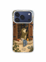 Otter at a wooden window with an ochre pear, cream cup and dusty blue cloth on an iPhone 17 Pro case