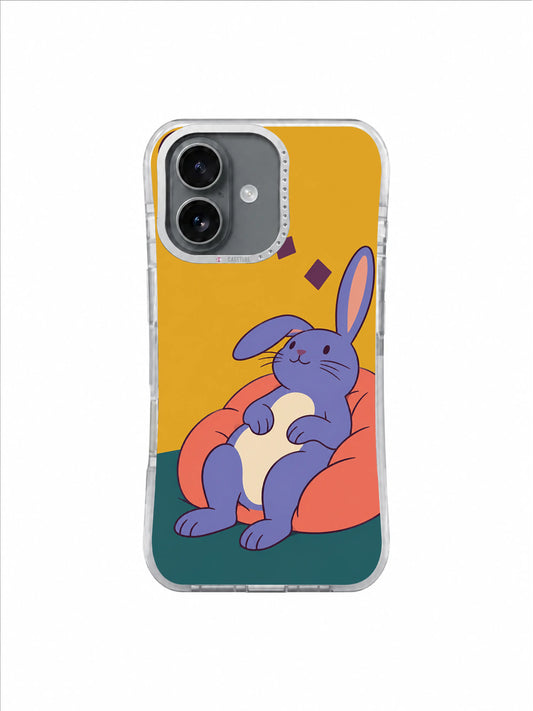 Blue-violet rabbit resting on a coral beanbag with one relaxed ear on an ochre iPhone case