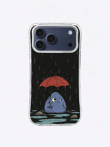 Quiet blue creature sheltering under a red umbrella in rain