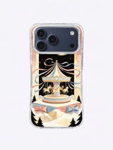 Powder Blue Ribbon Carousel artwork on an iPhone 17 Pro Max case with bows, snow terraces, and pine trees