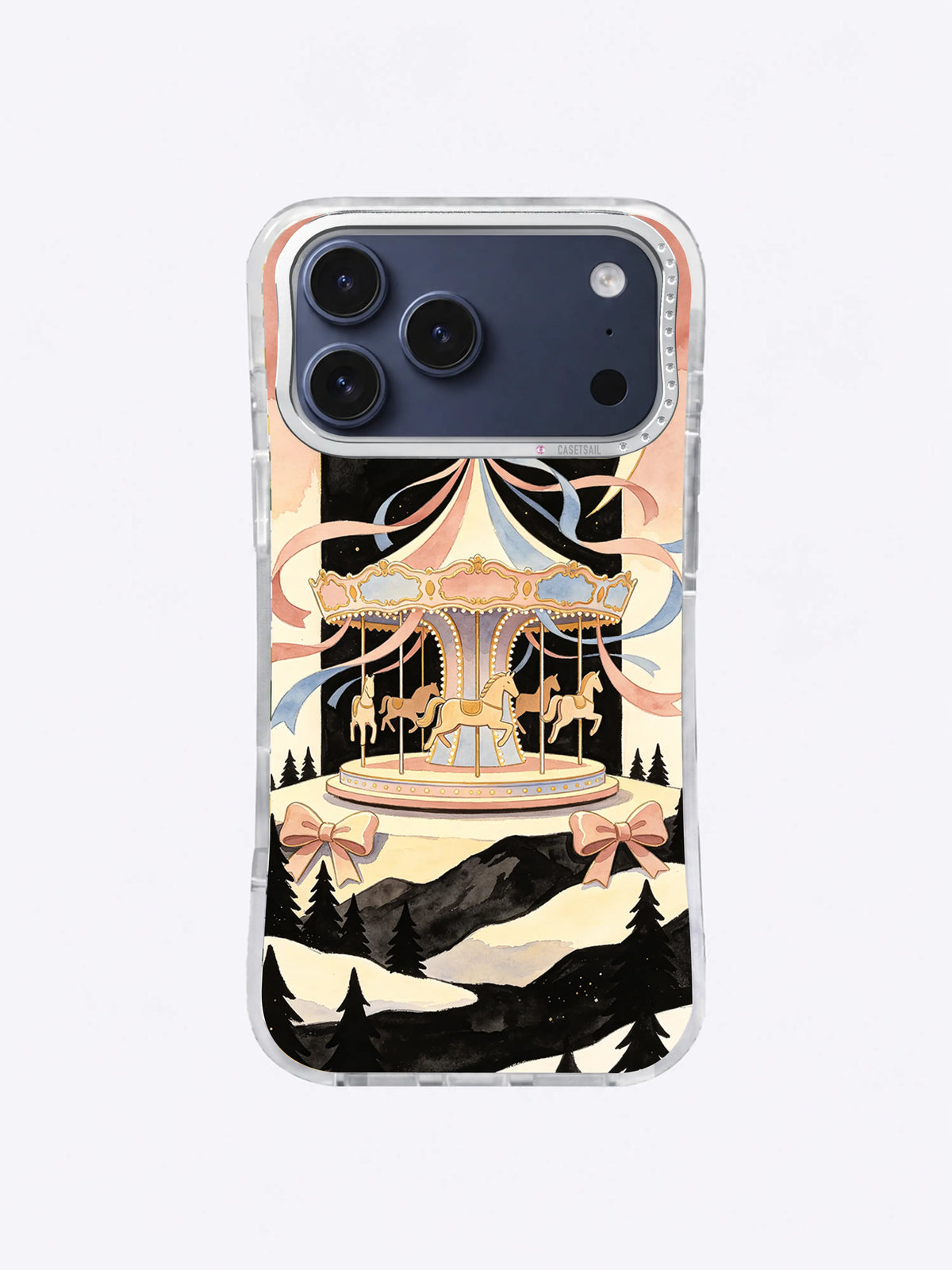 Snow Terrace Moon Carousel artwork on an iPhone 17 Pro Max case with cream ribbons and dark mountain silhouettes