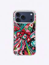 Turquoise Ribbon Flight artwork on an iPhone case with a diagonal bow rocket, curling ribbons, planets, gears, green accents, and patterned wedges