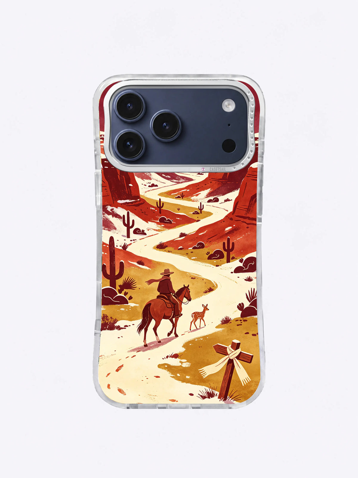 Small fawn beside a western rider among red mesas and cactus silhouettes on an iPhone 17 Pro Max case