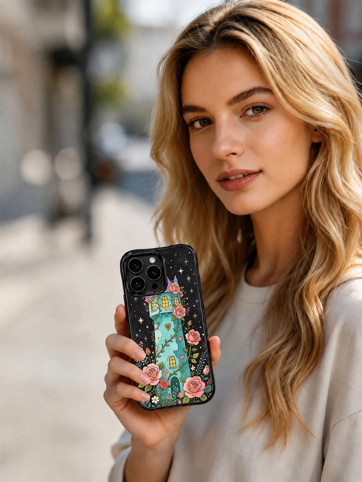Rose Moon Tower: Person holding the illustrated case outdoors.