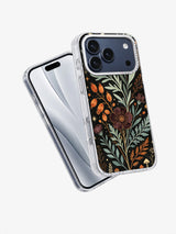 Angled view of Sage Moon Herbarium iPhone case with sage leaves, rust pods, and dark floral art