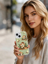 Woman holding the Sage Woodland Noel iPhone 15 case