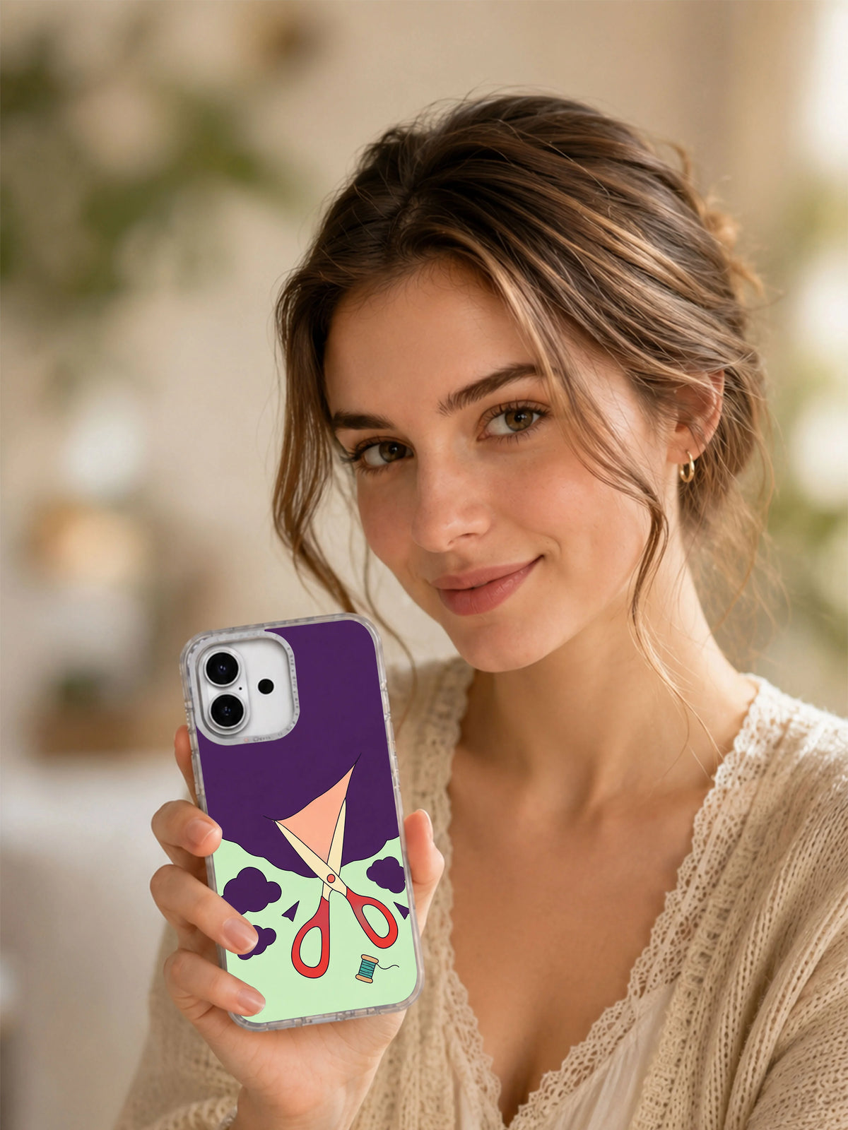 Lifestyle portrait holding the Scissors Open the Weather illustrated iPhone case