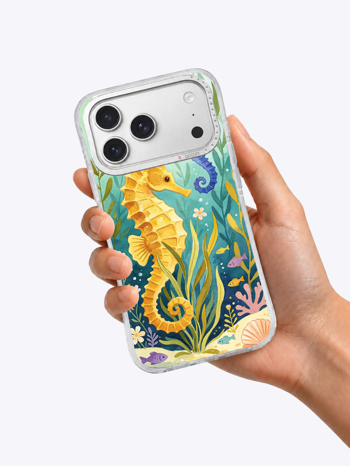 Seahorse Meadow iPhone case held in hand