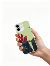 Seeds Across the Crack iPhone 16 case held in hand
