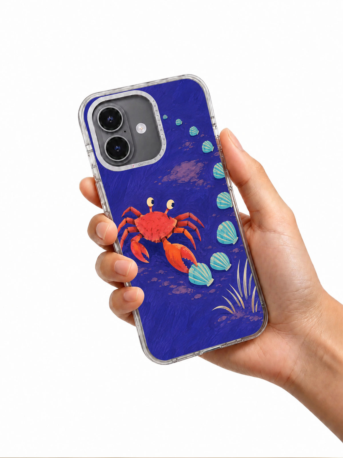 Hand holding the Sideways Is a Direction illustrated crab iPhone 17 case
