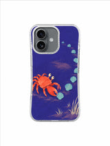 Confident crab walking sideways beside pale shells and dune grass on an iPhone 17 case design