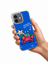Hand holding an iPhone 16 case with Sideways Still Gets There pink crab and ladder artwork
