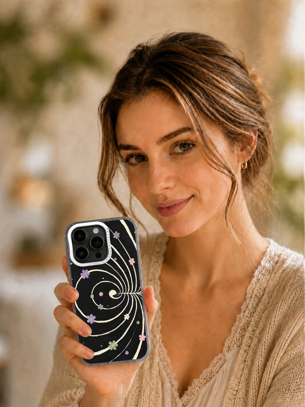 Woman presenting Silent Bloom Universe phone case
