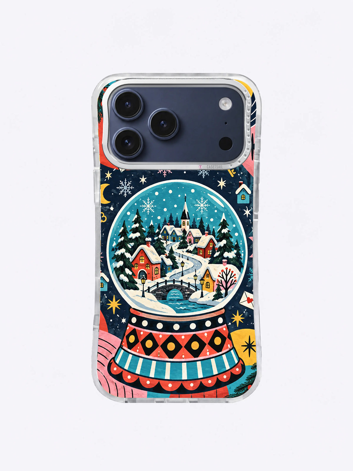 Aurora Village Globe artwork on an iPhone case with snowy cottages, dark fir trees, aqua sky, and coral and yellow accents