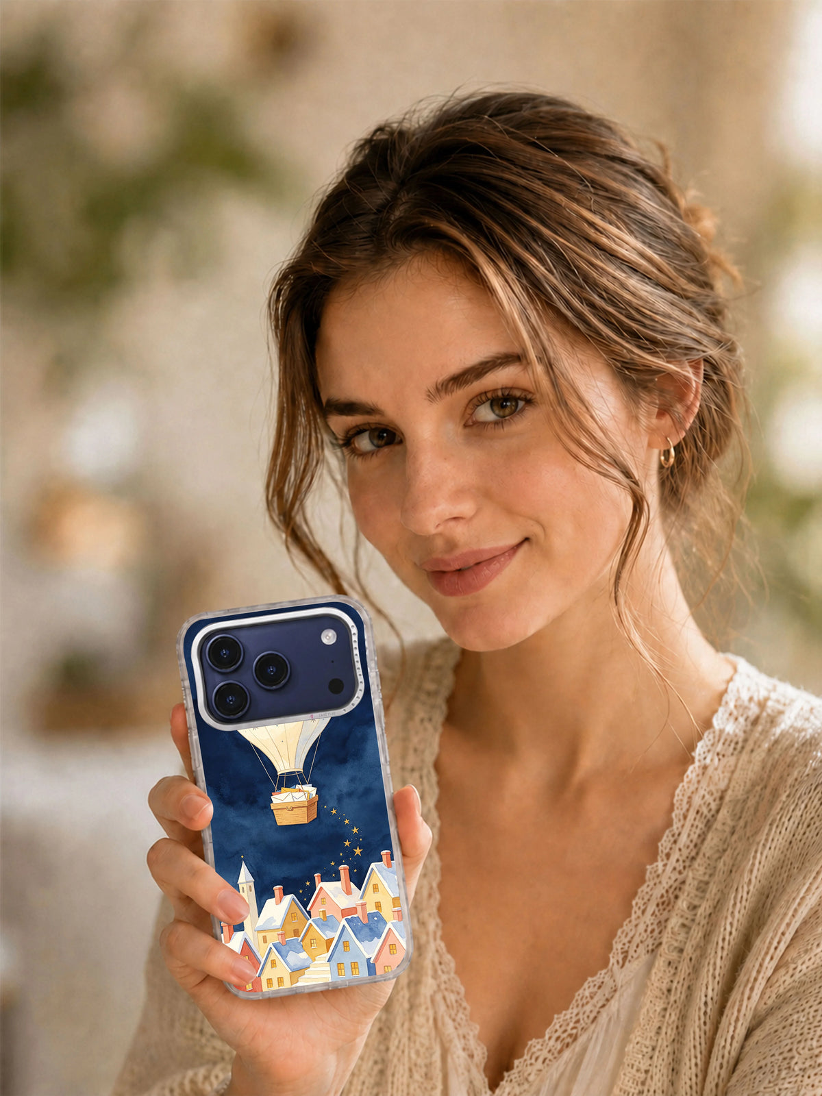 Lifestyle view of a person holding The Star Post Balloon iPhone 17 Pro Max case
