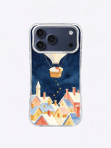 Star Post Balloon iPhone case pattern with a cream seed-pod balloon above a snowy coral and blue village
