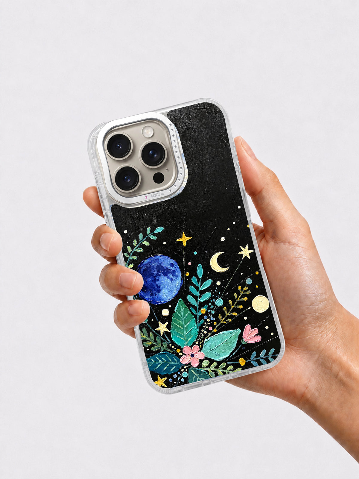 Hand holding celestial garden iPhone 16 Pro case