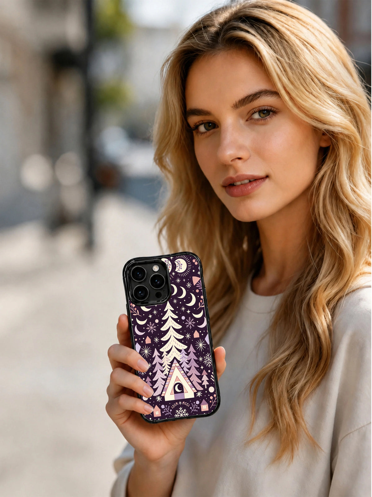 Woman holding the Starlit A-Frame Moon iPhone 13 Pro case outdoors