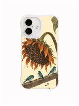 Seed Disc sunflower and teal bird artwork on an iPhone 16 case