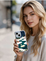 Person holding the Swan's Christmas Lake iPhone 14 case outdoors