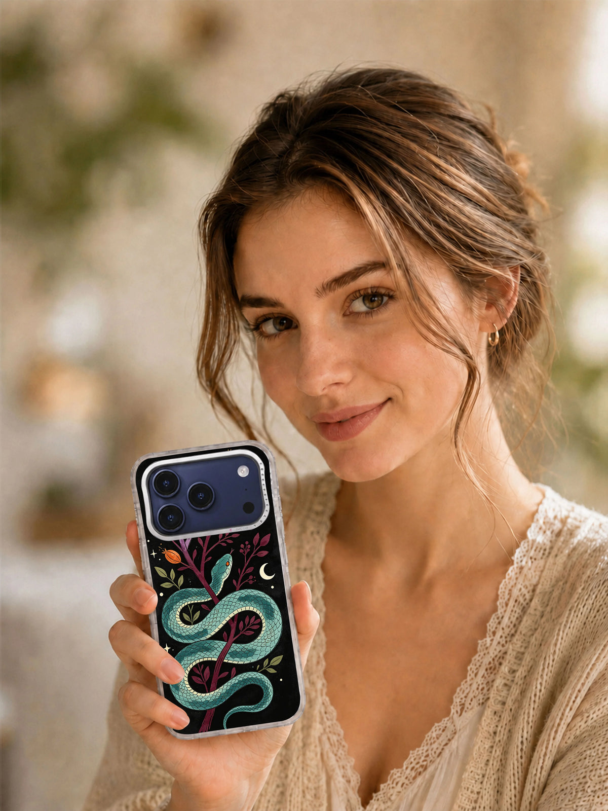 Lifestyle view of Teal Serpent Botanica iPhone case with teal serpent artwork