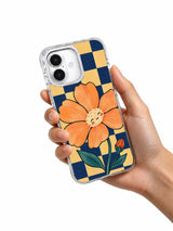 The Apricot Hour floral iPhone 17 case held in hand