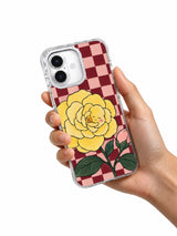 The Camellia Keeps a Secret floral iPhone 17 case held in hand