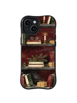 The December Reading Room iPhone 15 case with books, glasses, candle and holiday greenery