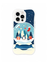 Clear-edge iPhone 15 Pro case with a penguin snow globe, navy firs, coral stars, red stocking and cream wave base