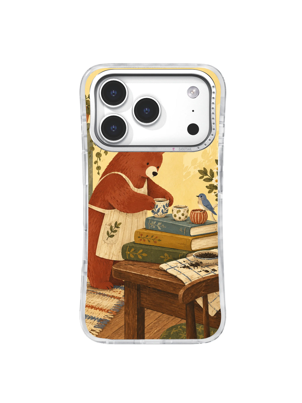 Dusty-blue bird beside three ceramic cups arranged by a bear on an iPhone 17 Pro case