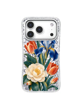 Coral tulips frame a cream camellia and blue iris on a transparent iPhone 17 Pro case