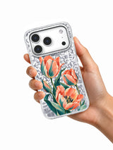 Hand holding the Tulips on the Upbeat iPhone 17 Pro case with coral and teal artwork