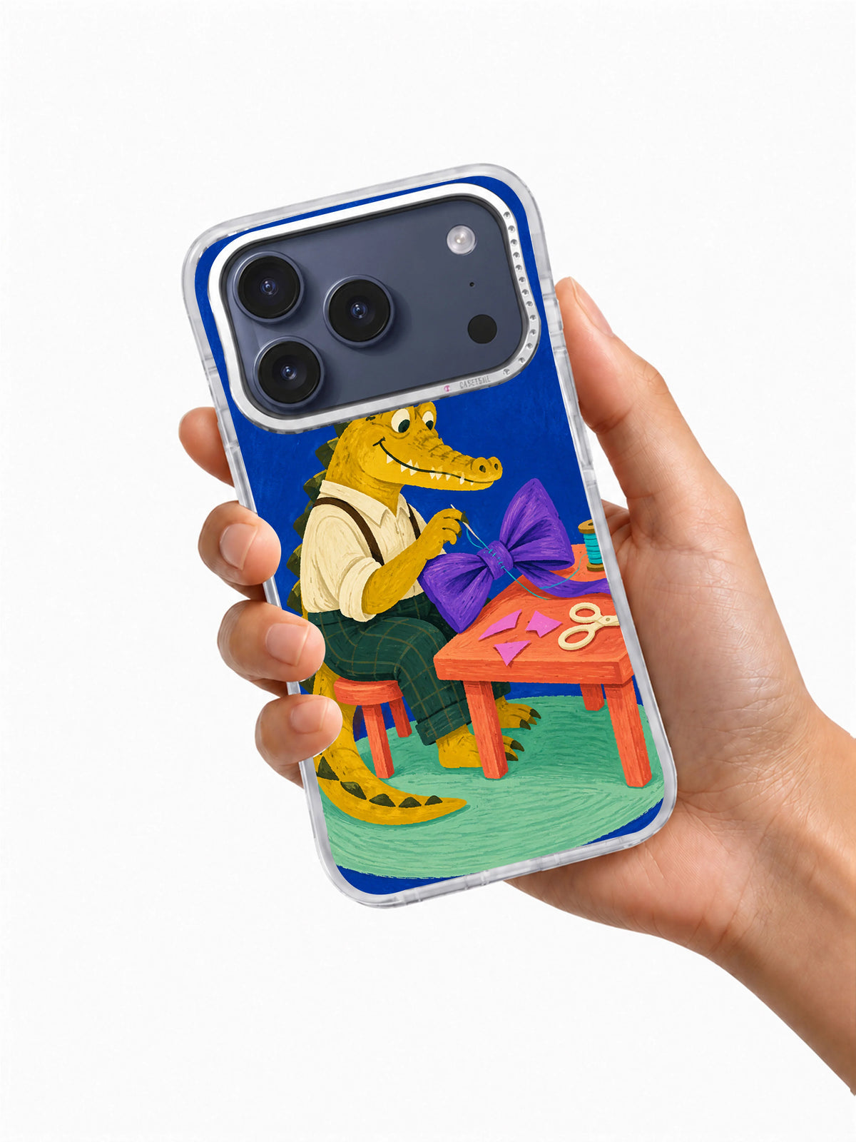 Hand holding transparent iPhone case with Violet Bow Tailor artwork