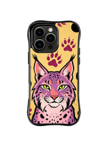 Pink lynx with tufted ears and yellow-green eyes beneath purple paw prints on iPhone 13 Pro Max case