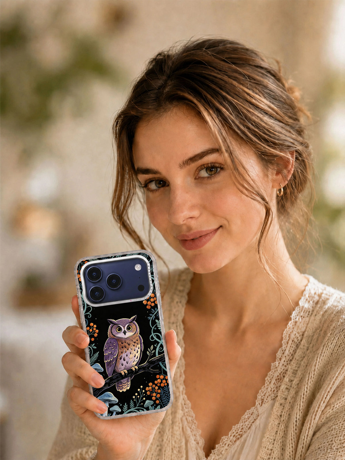 Lifestyle view of Violet Owl Garden iPhone case with owl, teal vines, and orange berry details