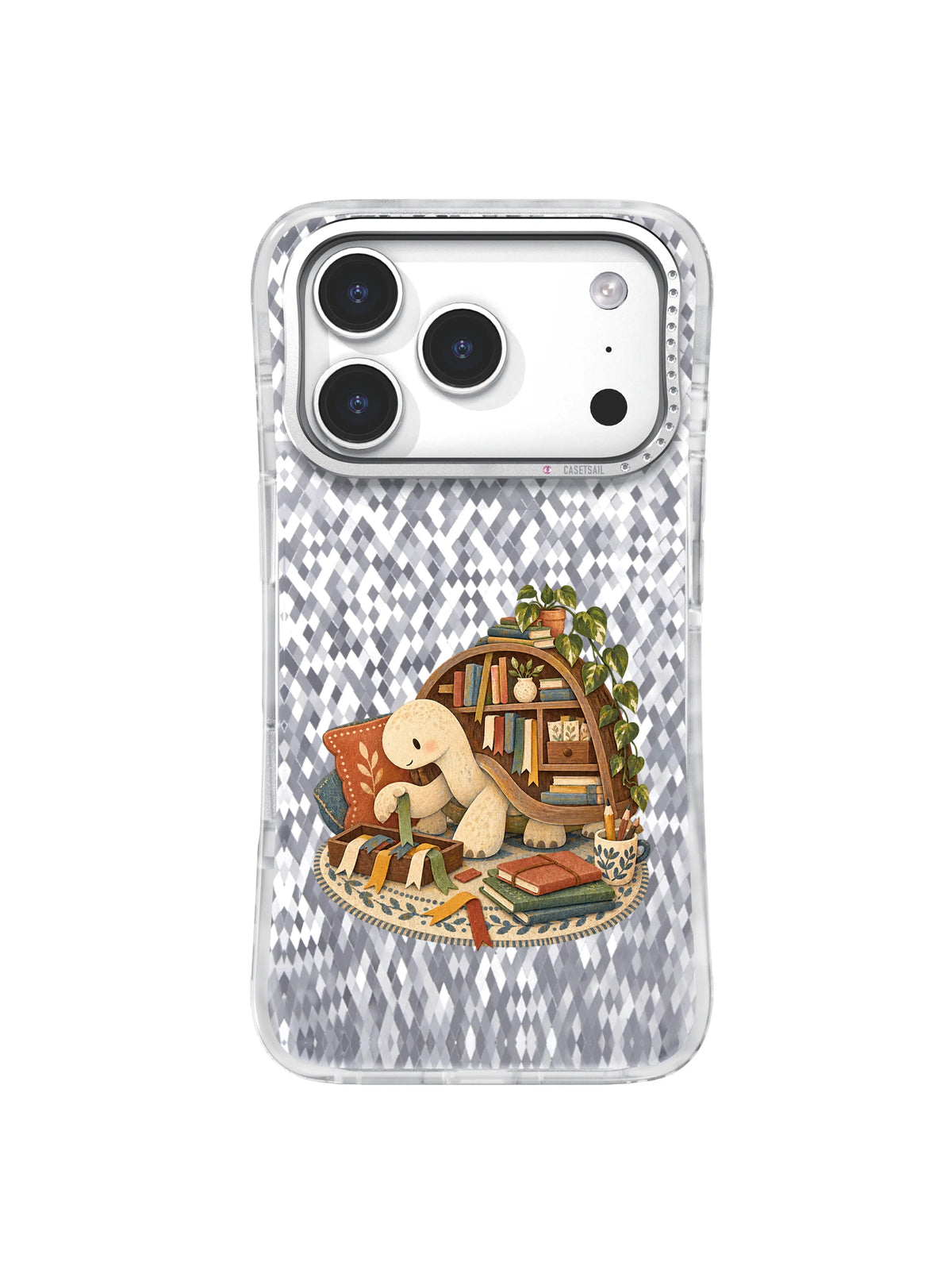 Cream turtle gathering colorful ribbon bookmarks on an oval rug on an iPhone 17 Pro case