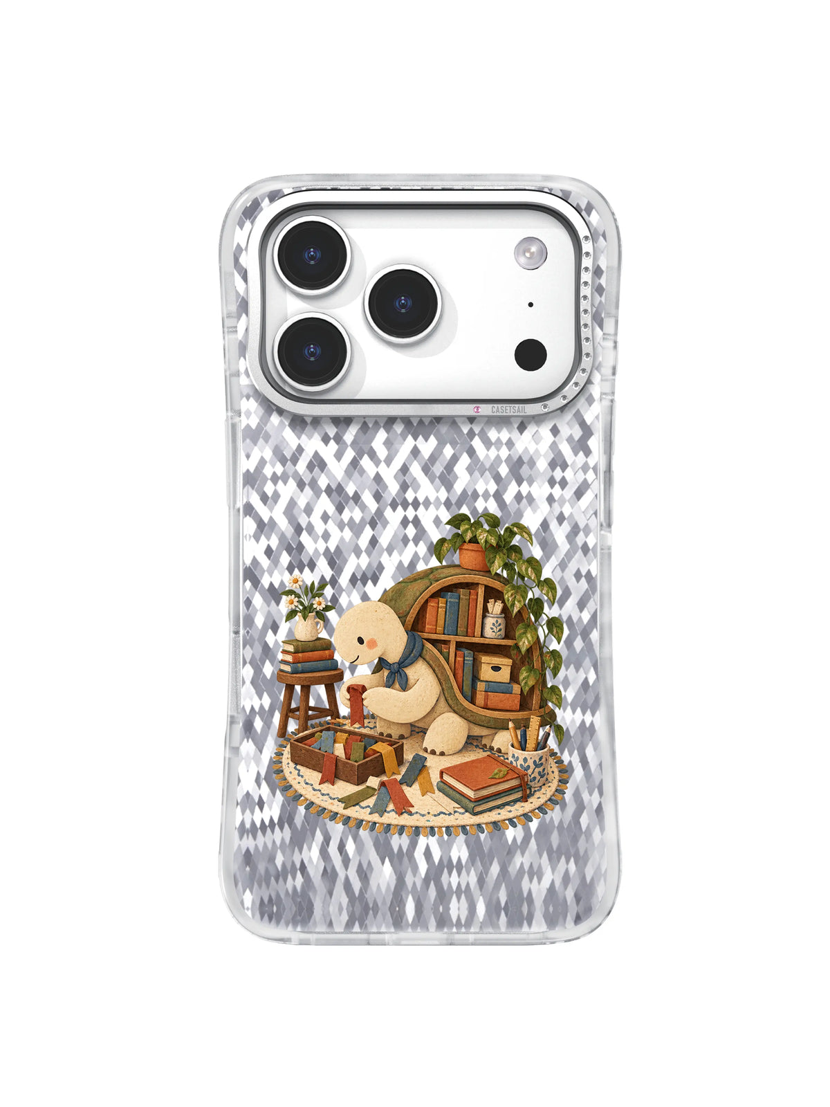Cream turtle beside a curved shell bookshelf and stacked books on an iPhone 17 Pro case