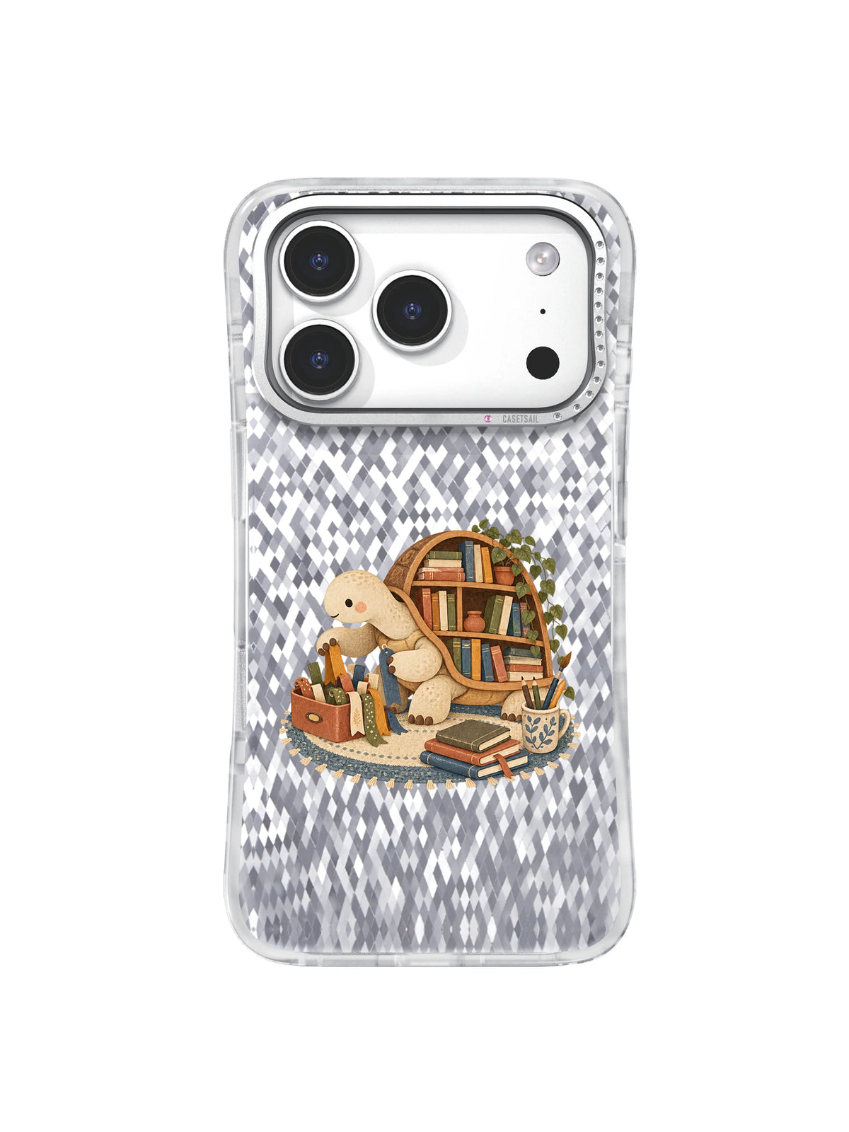 Cream turtle sorting ribbon bookmarks beside a shell bookshelf on an iPhone 17 Pro case