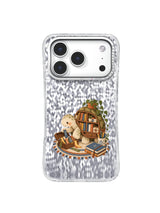 Cream turtle and miniature shell library with books and ribbon markers on an iPhone 17 Pro case