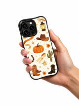 Western Pumpkin Ranch Night iPhone 14 Pro case held in hand