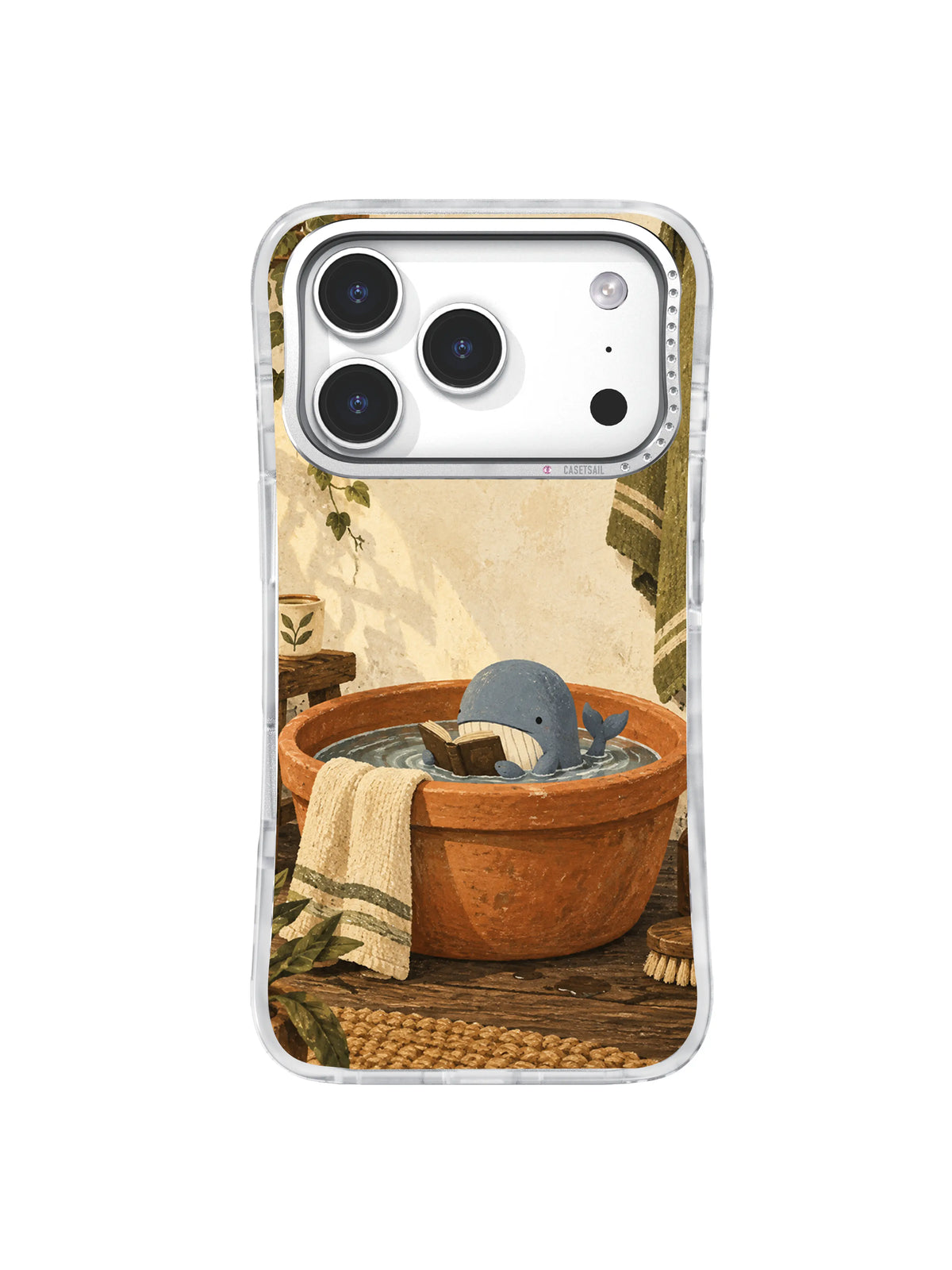 Blue whale resting with a book in a warm terracotta washbasin on an iPhone 17 Pro case