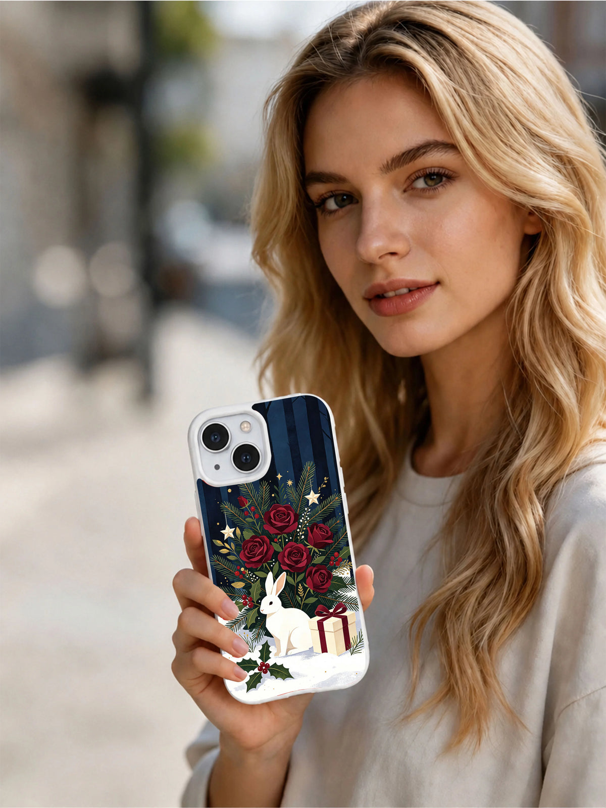 Person holding the white hare Christmas rose iPhone 14 case