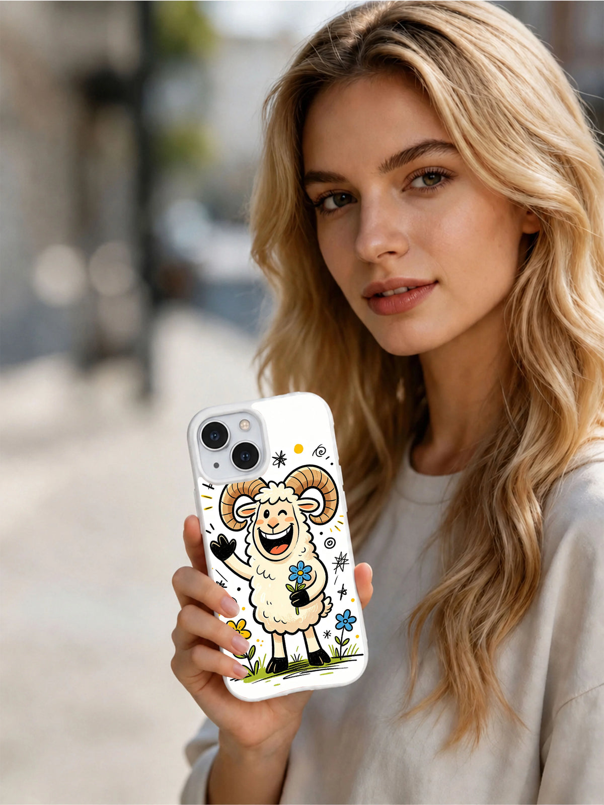 Lifestyle view of a woman holding the Wildflower Ram iPhone 13 case
