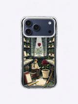 Oxblood rose in a cream pot beside books and specimen cards on an iPhone 17 Pro Max case