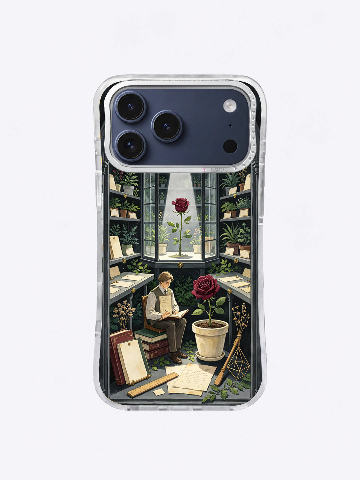 Oxblood rose in a cream pot beside books and specimen cards on an iPhone 17 Pro Max case