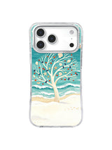 Shell ornaments and layered turquoise tides frame a winter beach tree on an iPhone 17 Pro case