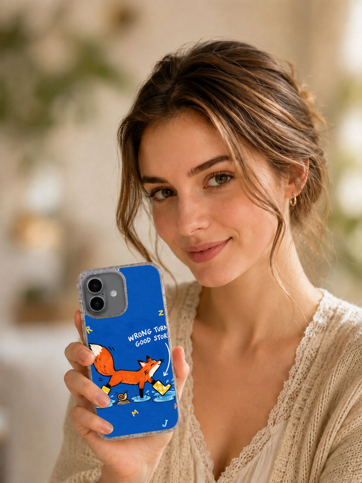 Model holding the Wrong Turn, Good Story iPhone 16 case